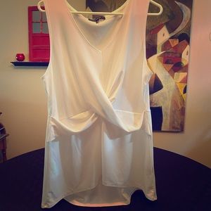 Sleeveless white top.